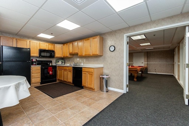 kitchen featuring black appliances, a drop ceiling, light tile patterned flooring, and pool table