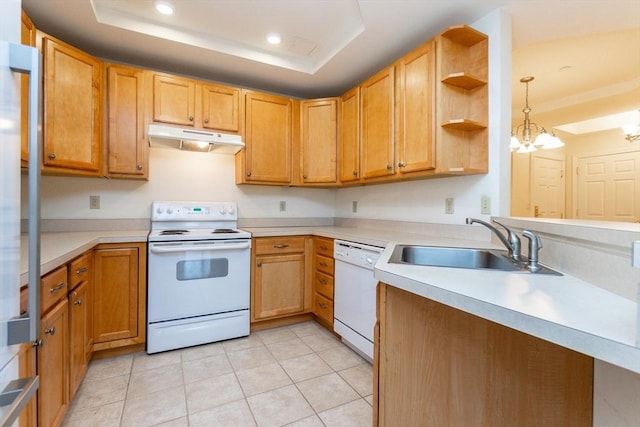 kitchen with sink, a notable chandelier, decorative light fixtures, white appliances, and a tray ceiling