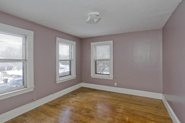 unfurnished room with wood-type flooring