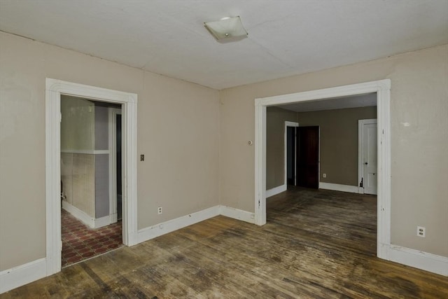 empty room with dark wood-type flooring