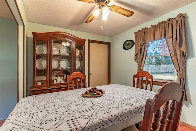 dining area with a textured ceiling and ceiling fan