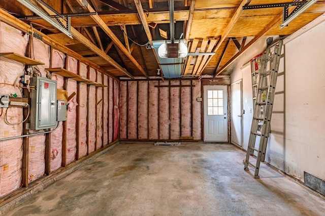 garage featuring electric panel and a garage door opener