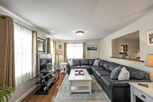 living area with wood finished floors and baseboards