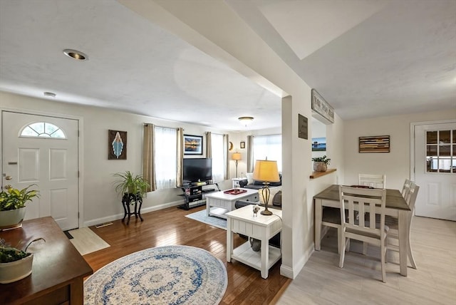 living area with wood finished floors and baseboards