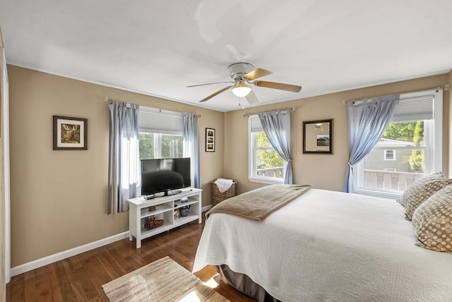 bedroom featuring baseboards, dark wood-style floors, and a ceiling fan