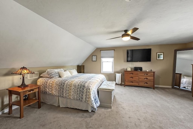 carpeted bedroom featuring vaulted ceiling, a ceiling fan, and baseboards