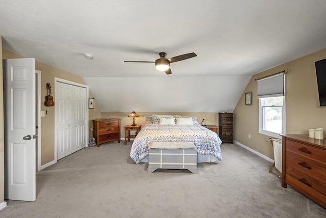 bedroom featuring baseboards, carpet flooring, vaulted ceiling, a ceiling fan, and a closet