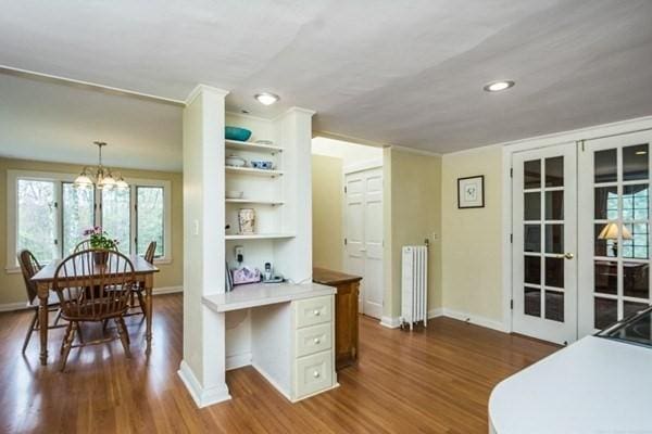 interior space featuring french doors, radiator, baseboards, and dark wood finished floors