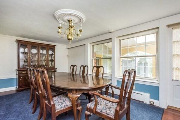 dining space with a notable chandelier and baseboards