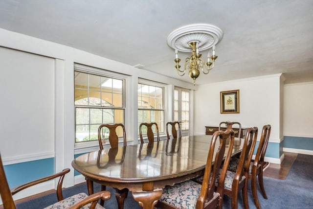 dining room with an inviting chandelier and baseboards