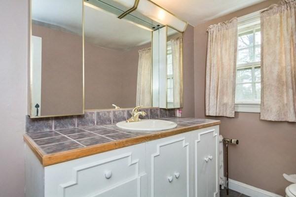 bathroom with vanity, baseboards, and toilet