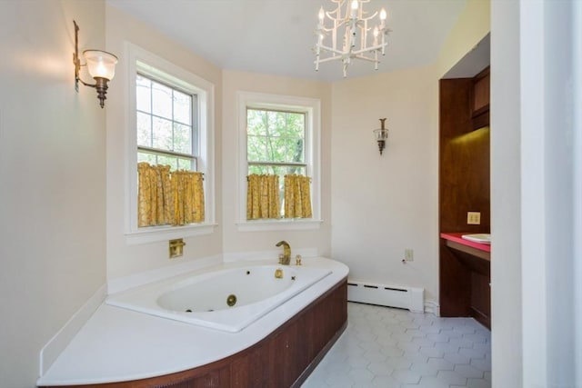 bathroom featuring vanity, an inviting chandelier, a baseboard heating unit, and a tub with jets