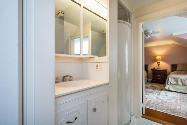 ensuite bathroom with ceiling fan, vaulted ceiling, ensuite bathroom, and vanity