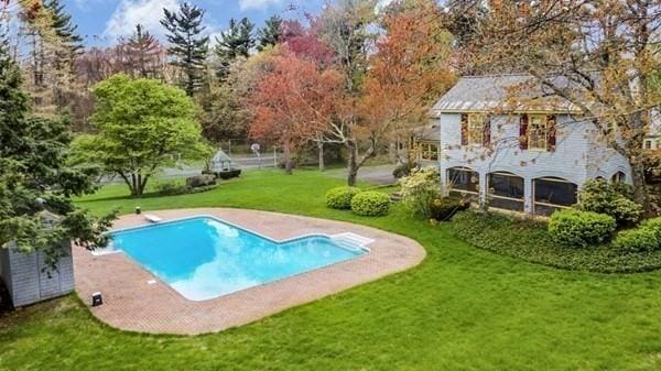 pool with a yard and a diving board