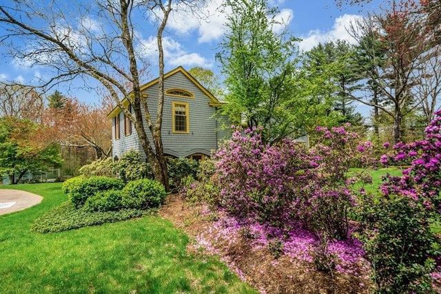 view of side of home featuring a lawn