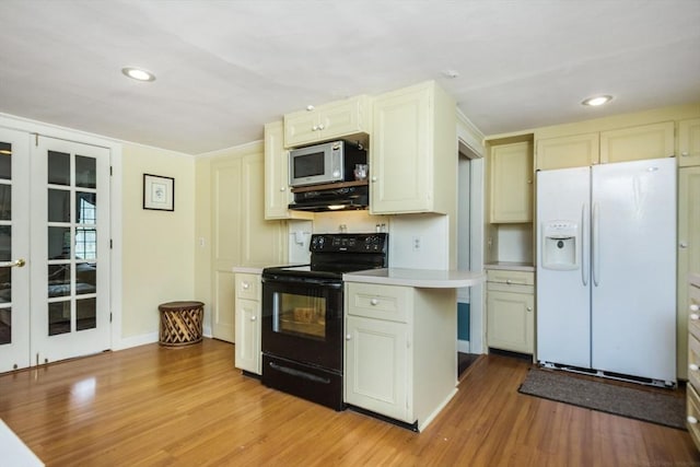 kitchen with range hood, light countertops, white appliances, light wood finished floors, and recessed lighting