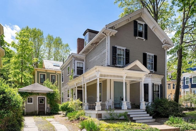 31 Boylston St, Boston, MA 02130 - view of front of house with covered porch and a chimney