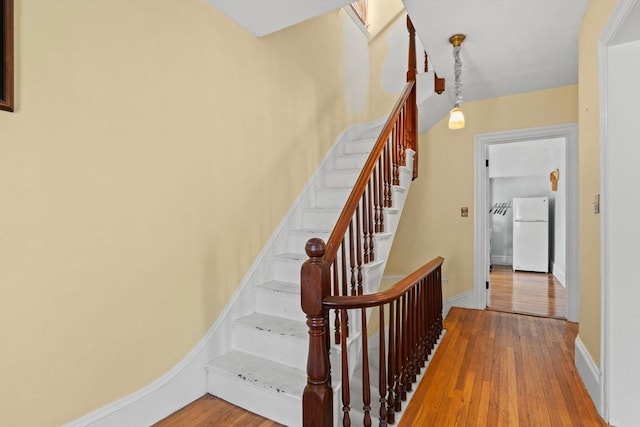 31 Boylston St, Boston, MA 02130 - staircase featuring wood-type flooring and baseboards