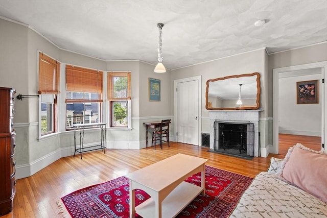 31 Boylston St, Boston, MA 02130 - living area featuring wood finished floors, healthy amount of natural light, crown molding, a fireplace with flush hearth, and baseboards