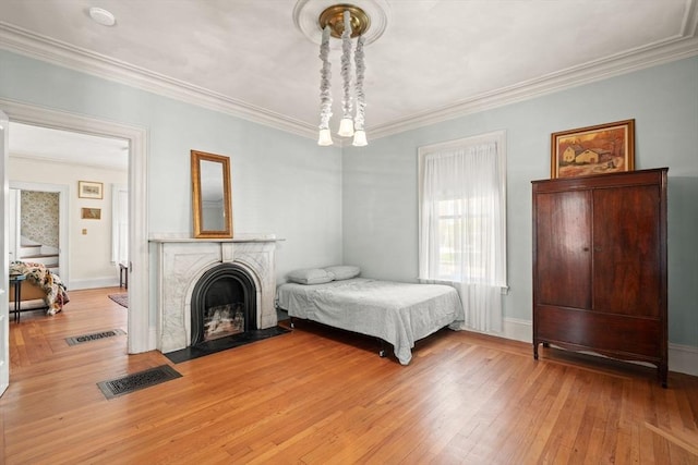 31 Boylston St, Boston, MA 02130 - bedroom with light wood-type flooring, ornamental molding, a fireplace with flush hearth, and baseboards