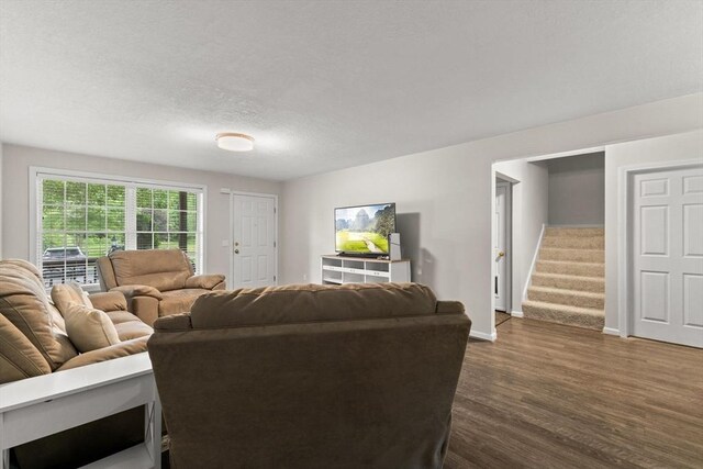 48 Finch Rd Unit 2, Raynham, MA 02767 - living room featuring dark wood-style flooring, stairway, and a textured ceiling