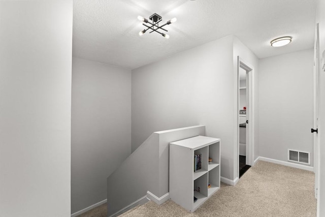48 Finch Rd Unit 2, Raynham, MA 02767 - hall with an upstairs landing, carpet floors, a textured ceiling, and a chandelier