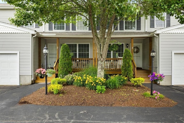 48 Finch Rd Unit 2, Raynham, MA 02767 - view of front of house with covered porch and a garage