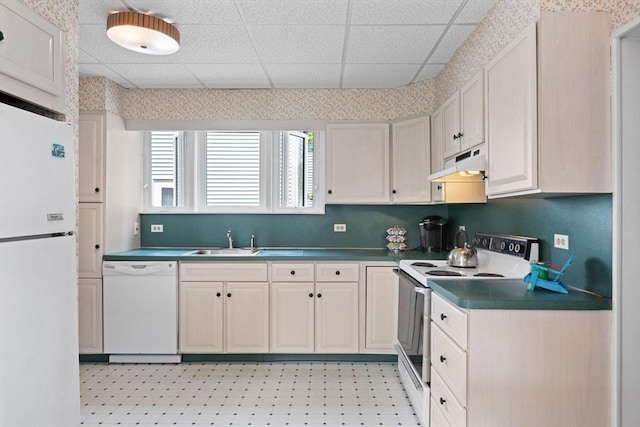 8A 3rd St, Medford, MA 02155 - kitchen featuring white appliances, under cabinet range hood, a paneled ceiling, dark countertops, and light floors