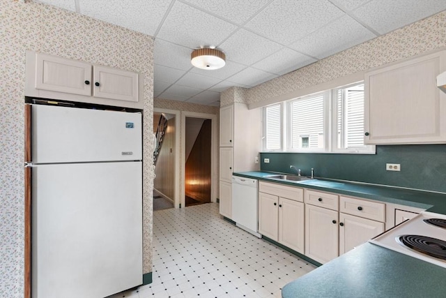 8A 3rd St, Medford, MA 02155 - kitchen with white appliances, dark countertops, light flooring, a drop ceiling, and wallpapered walls