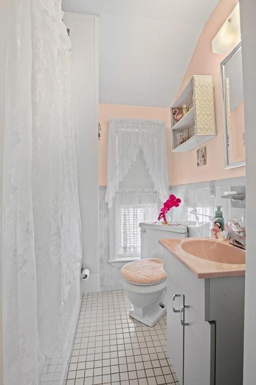 8A 3rd St, Medford, MA 02155 - full bathroom featuring tile walls, vanity, tile patterned flooring, lofted ceiling, and a shower with curtain