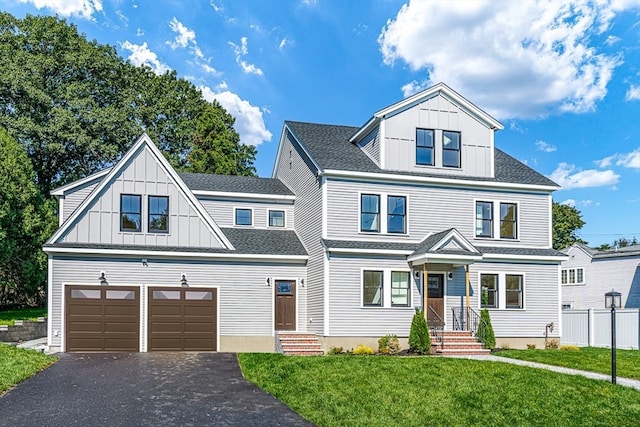 view of front of home featuring a garage and a front lawn