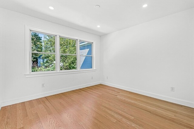 empty room with hardwood / wood-style flooring