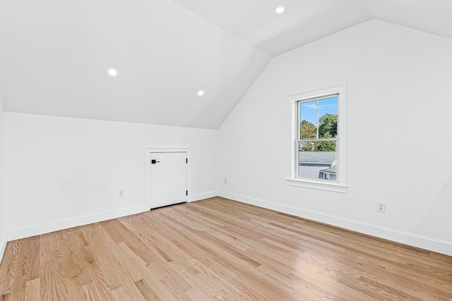 bonus room featuring lofted ceiling and light hardwood / wood-style flooring