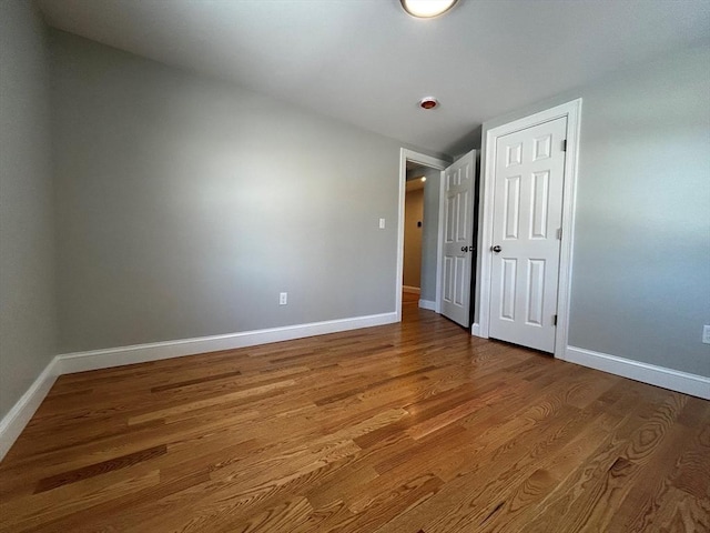 empty room with wood-type flooring