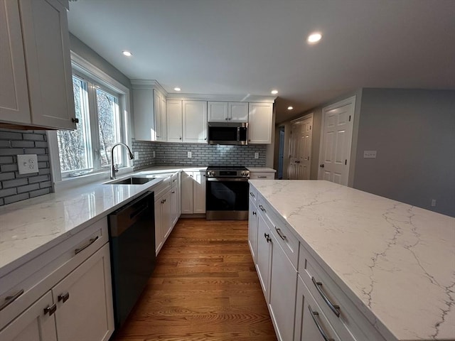 kitchen featuring appliances with stainless steel finishes, sink, and white cabinets