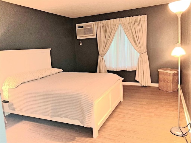 300 Candlewood Park Unit 32, Nashua, NH 03062 - bedroom with light wood-style floors, a wall mounted AC, and baseboards