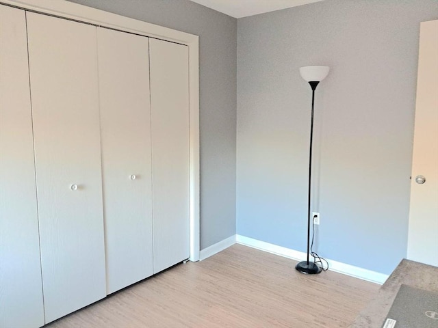 300 Candlewood Park Unit 32, Nashua, NH 03062 - unfurnished bedroom with light wood-style floors, a closet, and baseboards