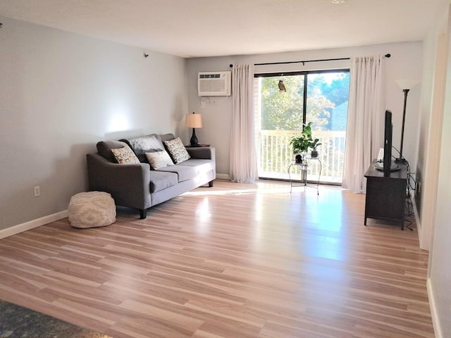 300 Candlewood Park Unit 32, Nashua, NH 03062 - living area featuring light wood-style floors, baseboards, and a wall mounted air conditioner