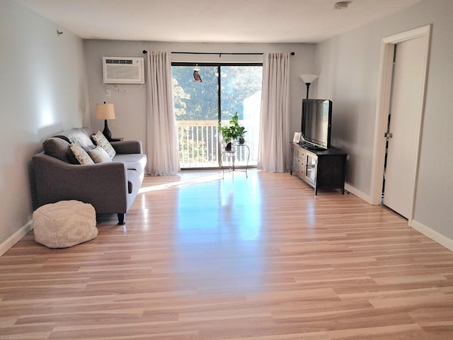 300 Candlewood Park Unit 32, Nashua, NH 03062 - living area with light wood finished floors, a wall mounted air conditioner, and baseboards