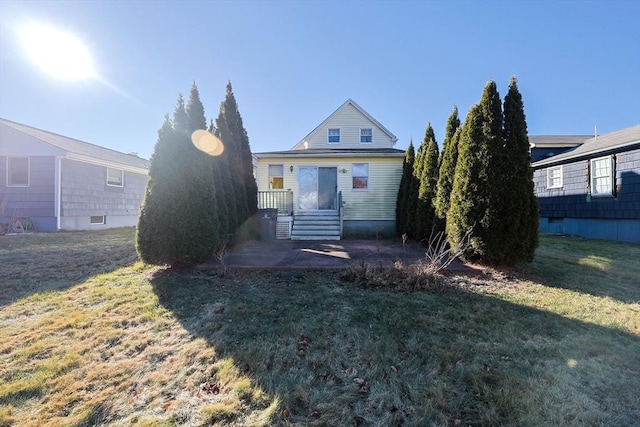 view of front of home with a front yard and a patio area