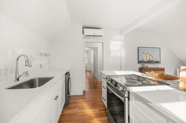 kitchen featuring a wall mounted air conditioner, light hardwood / wood-style floors, stainless steel electric range oven, and white cabinetry