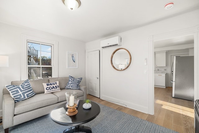 living room with a wall mounted air conditioner, wood-type flooring, and crown molding