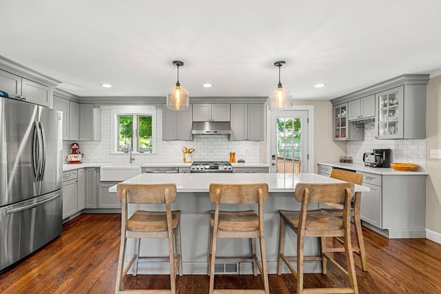 11 Bruce Ln, Wenham, MA 01984 - kitchen with gray cabinets, freestanding refrigerator, under cabinet range hood, range, and backsplash