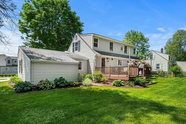 11 Bruce Ln, Wenham, MA 01984 - back of property featuring a deck, a yard, and roof with shingles