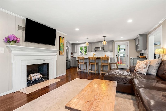 11 Bruce Ln, Wenham, MA 01984 - living area with crown molding, recessed lighting, dark wood-style flooring, a fireplace, and baseboards