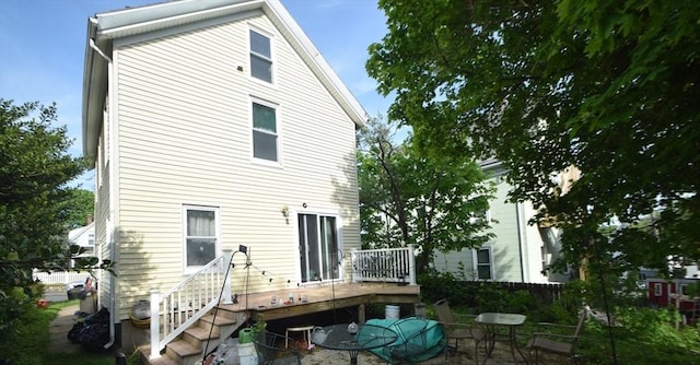 2 Harrison Ave, Gloucester, MA 01930 - rear view of house featuring a wooden deck and outdoor dining area