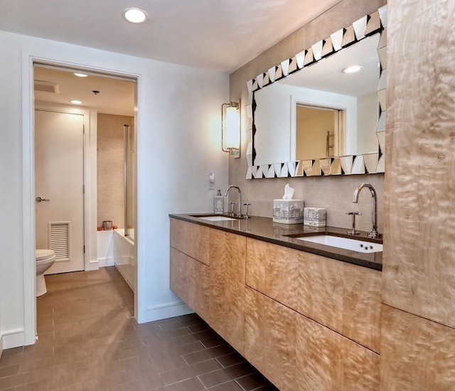 full bathroom with tile patterned floors, vanity, bathing tub / shower combination, and toilet