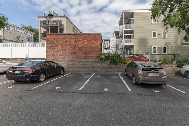 uncovered parking lot with stairs and fence