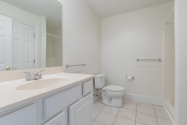 bathroom with vanity, baseboards, tile patterned flooring, walk in shower, and toilet