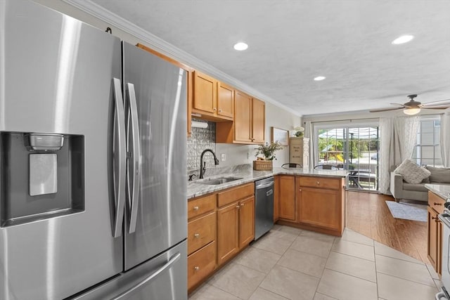 10 Sprucewood Ln Unit 10, Worcester, MA 01606 - kitchen featuring appliances with stainless steel finishes, ornamental molding, a peninsula, a ceiling fan, and light tile patterned flooring